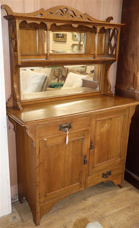 An Arts and Crafts oak side cabinet W.122cm